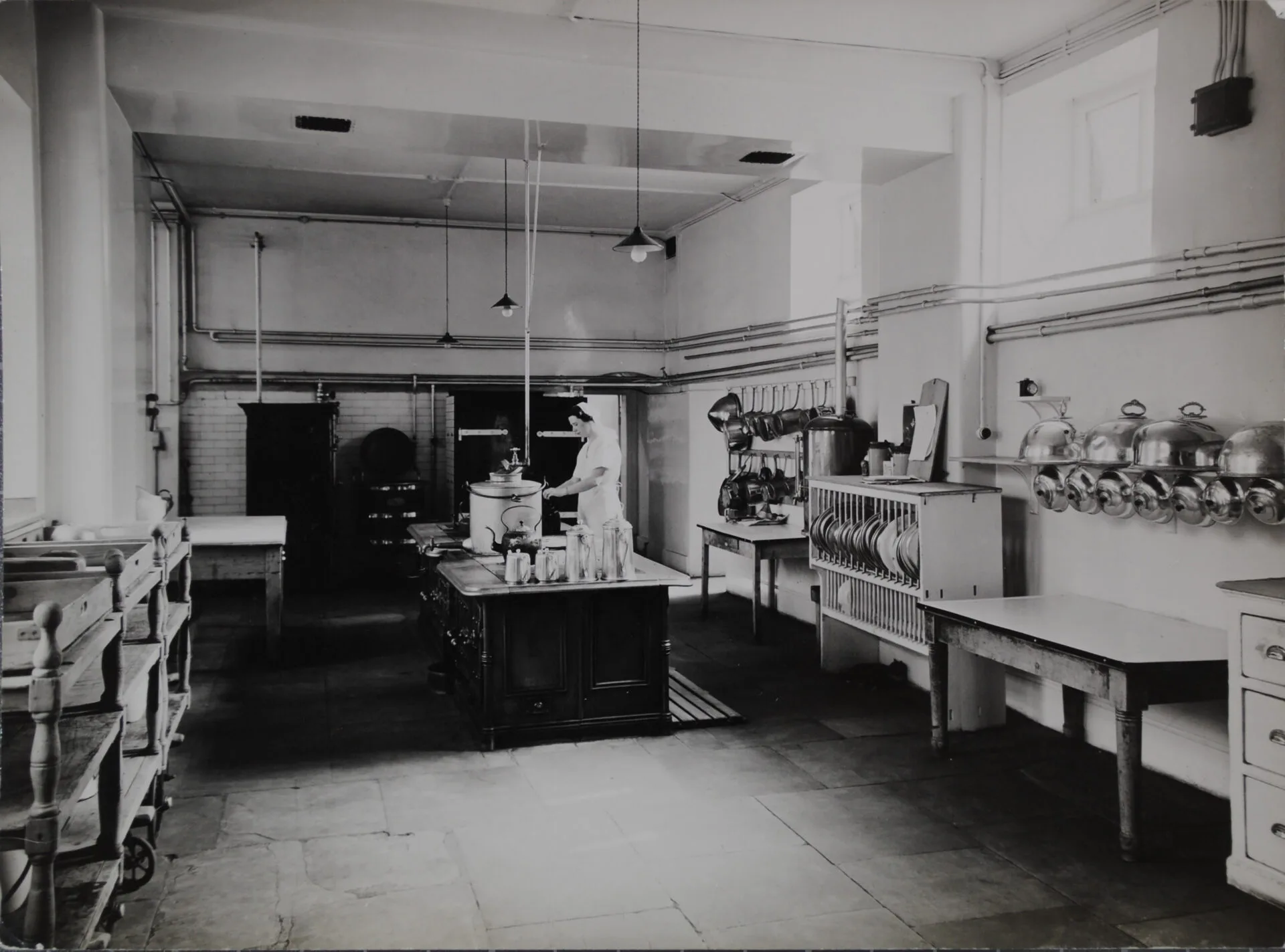 The kitchen superintendent, Miss Mary Ferguson, preparing a meal for patients in 1938. Mary worked at the Warneford from 1933 until her retirement in 1956. When she died later that year, a memorial service was held for her in the chapel, attended by 40 members of staff.
