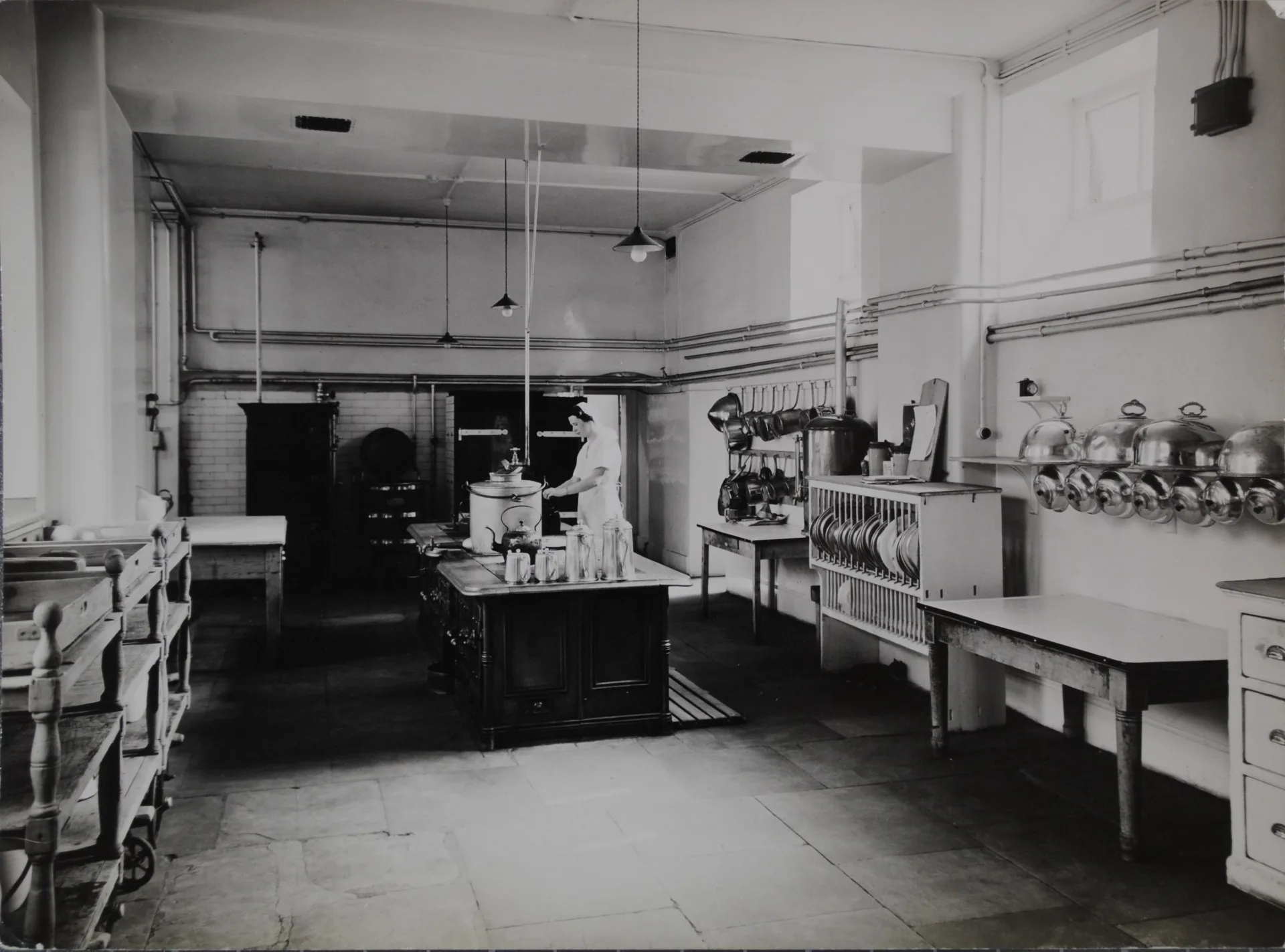 A nurse preparing refreshments in the Warneford kitchen in 1938. You may just be able to see a black cat under the table on the right.
Credit: Oxfordshire Health Archives OHA W10 A1/19