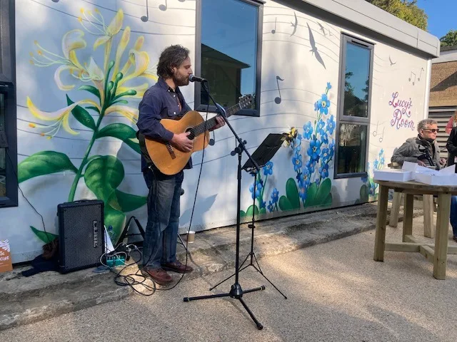 A music therapy session taking place outside Lucy’s Room. Credit: Tom Cox